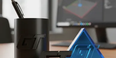 Black and blue triangular GT logos with a pen holder and computer monitor in the background.